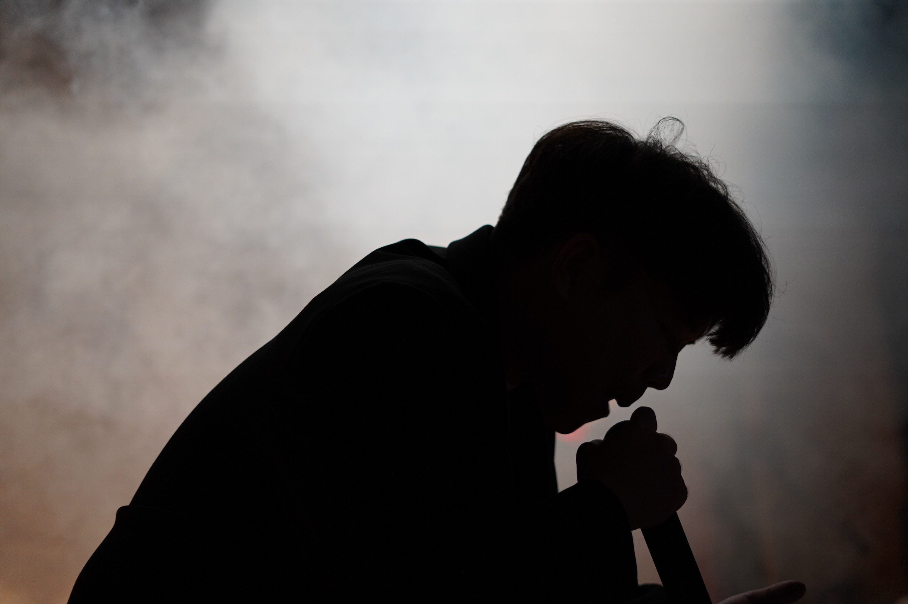 A vocalist silhouetted on stage